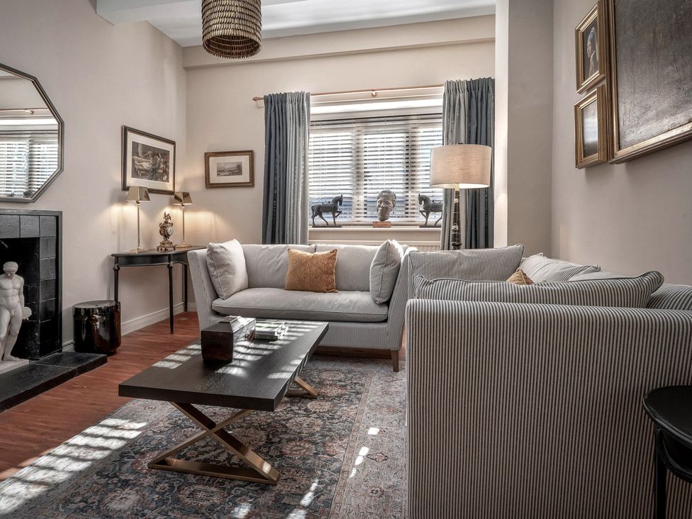 A living room with a sofa and a coffee table at Raphael Rooms in Peterborough