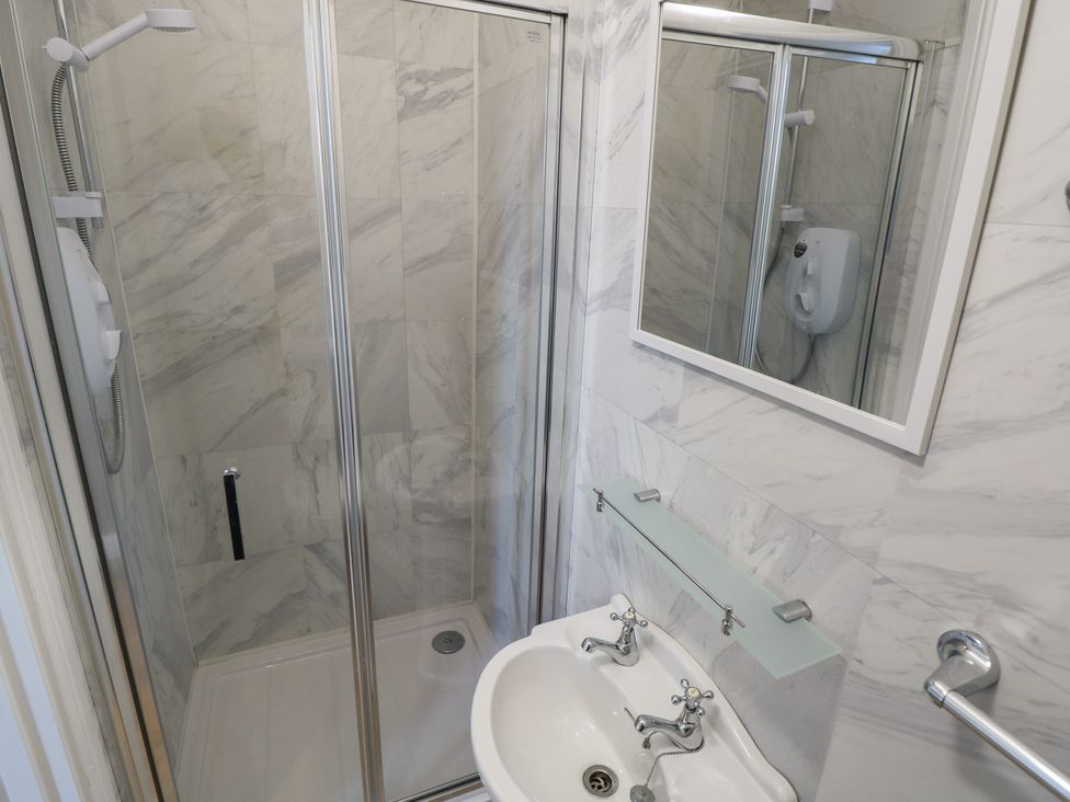 A shower and sink in a bathroom at The East Wing Apartment Claremorris