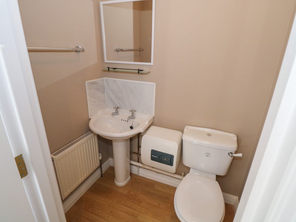 A bathroom with a sink and toilet at The East Wing Apartment in Claremorris