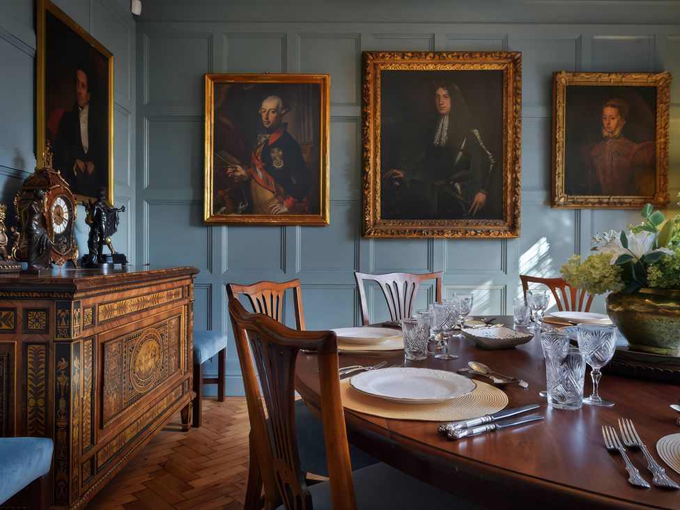 A dining room with a table set for dinner at Morland Manor in Peterborough