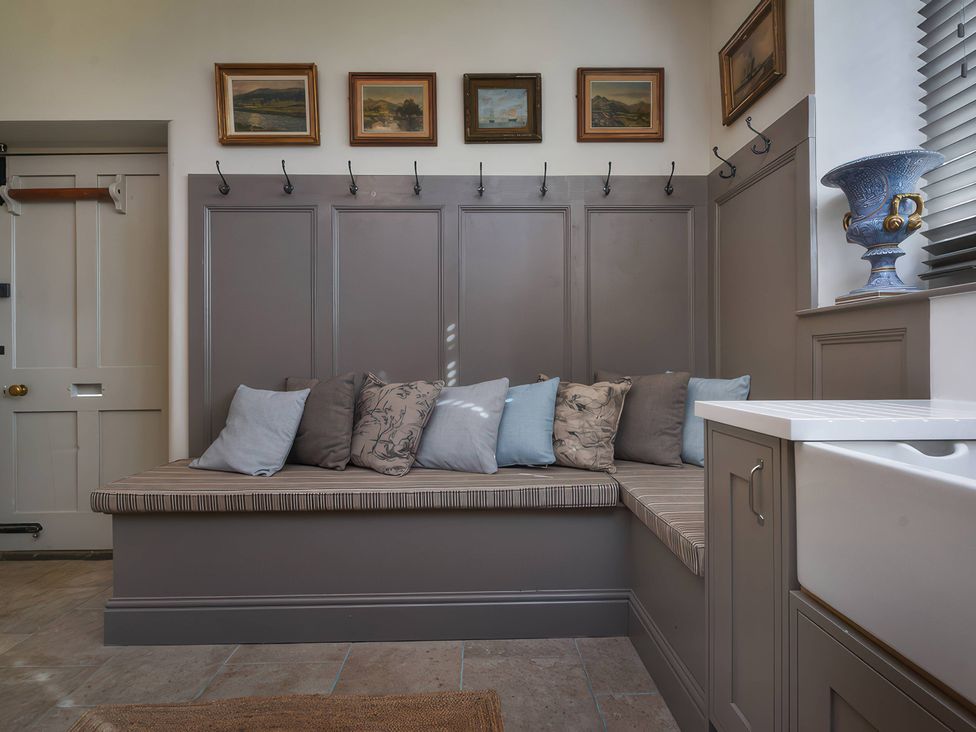 An entryway with a bench and cushions at Morland Manor in Peterborough