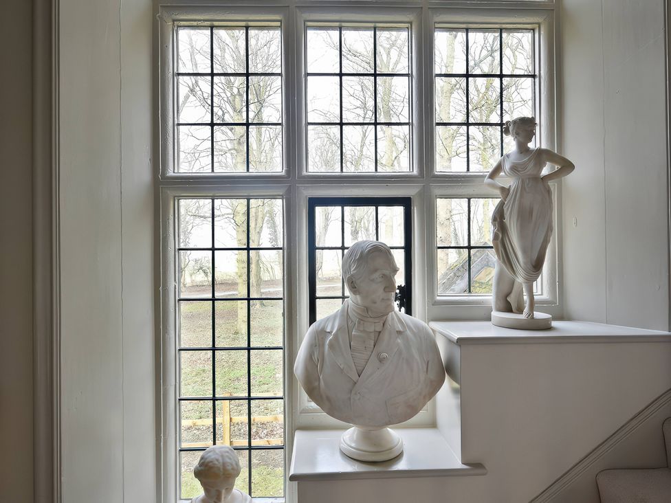 A window with statues on the sill at Morland Manor in Peterborough