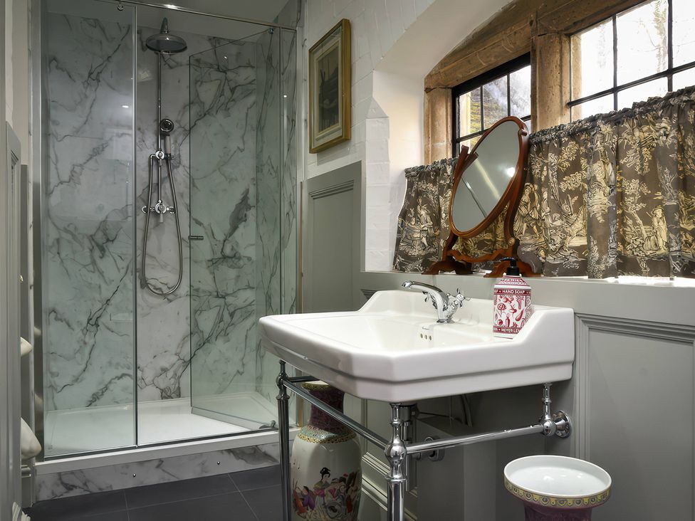 A bathroom with a shower and sink at Morland Manor in Peterborough