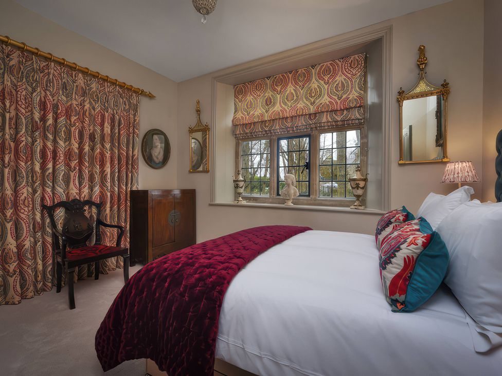 A bedroom with a bed and window at Morland Manor in Peterborough