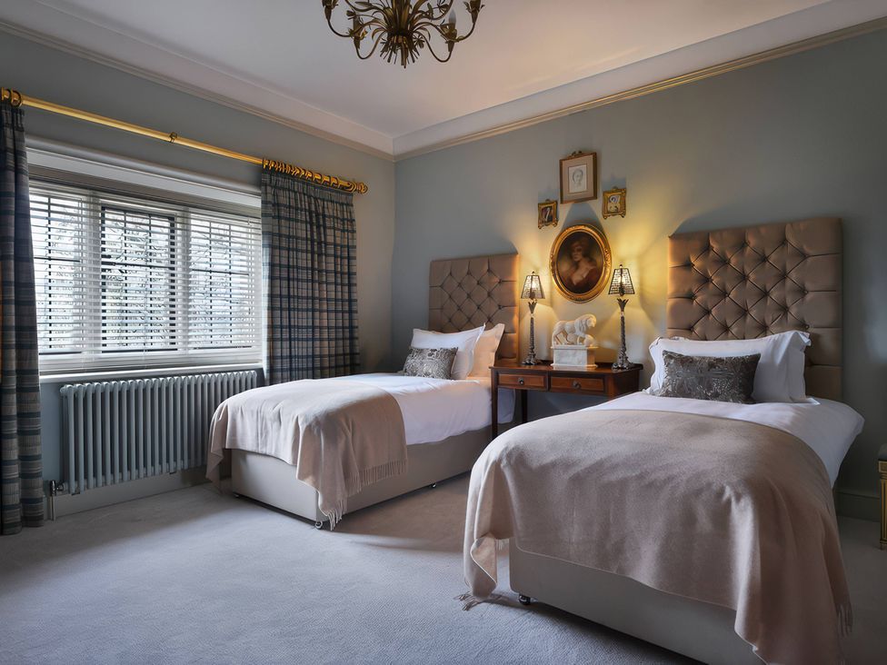 A bedroom with two beds and a nightstand at Morland Manor in Peterborough
