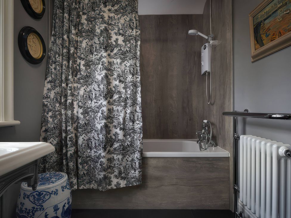 A bathroom with a bathtub and shower at Morland Manor in Peterborough