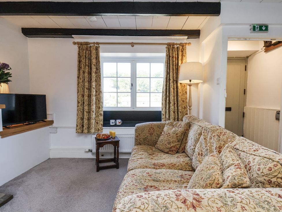 A living room with a sofa and television at Rigg Cottage in Sandsend