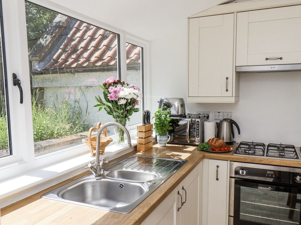 A kitchen with sink and countertop at Rigg Cottage in Sandsend