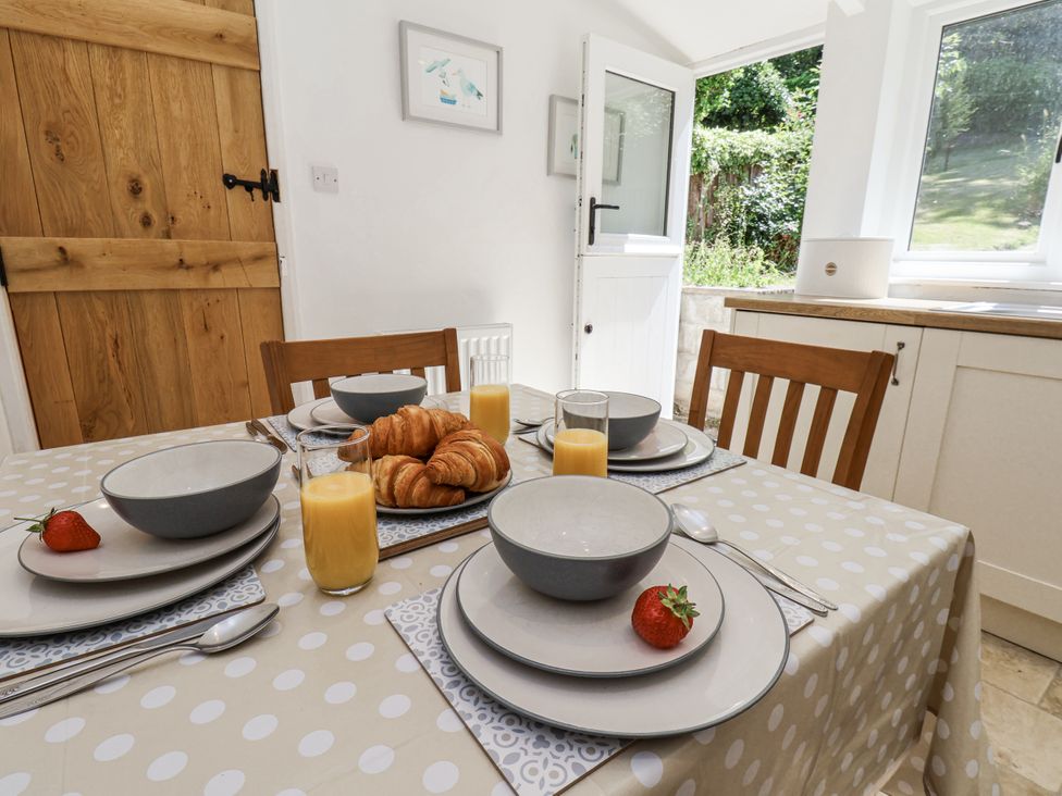 A dining room with a table set for breakfast at Rigg Cottage in Sandsend