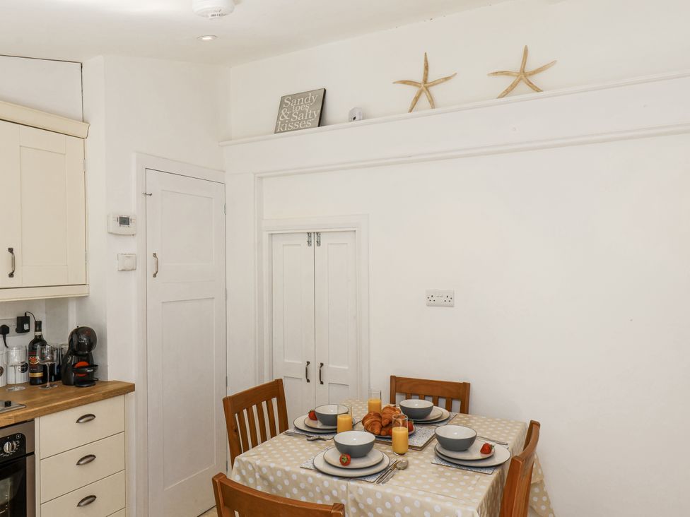 A kitchen with a dining table set for breakfast at Rigg Cottage in Sandsend
