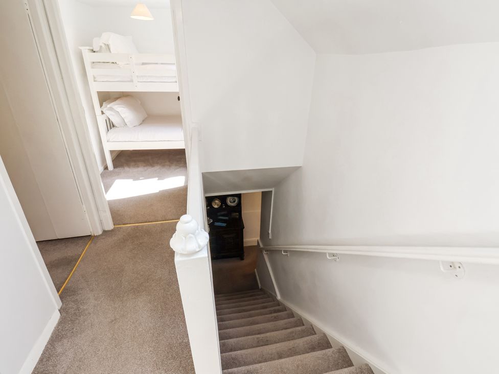 A staircase leading to a hallway with a bunk bed at Rigg Cottage Sandsend