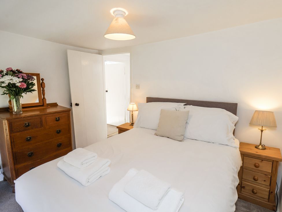 A bedroom with a bed and drawers at Rigg Cottage Sandsend