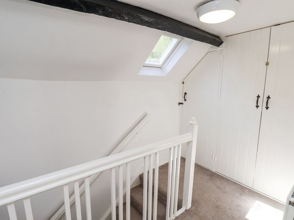 A staircase with a skylight and wardrobe at Rigg Cottage in Sandsend