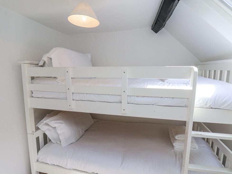 A bunk bed with pillows and sheets at Rigg Cottage Sandsend