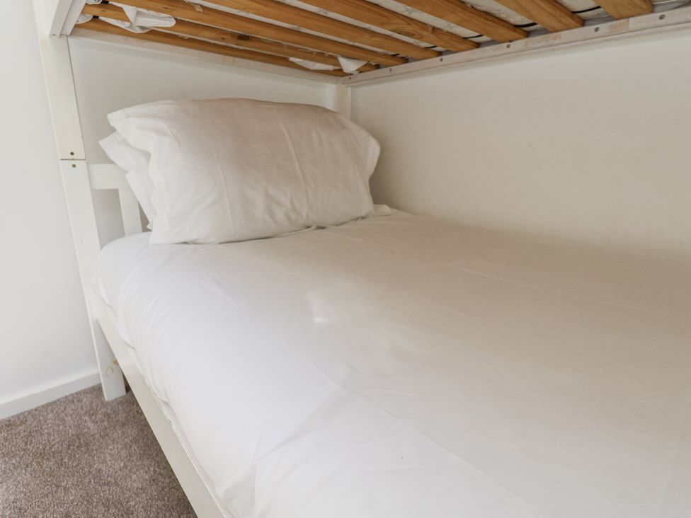 A bunk bed with a mattress and pillow at Rigg Cottage Sandsend