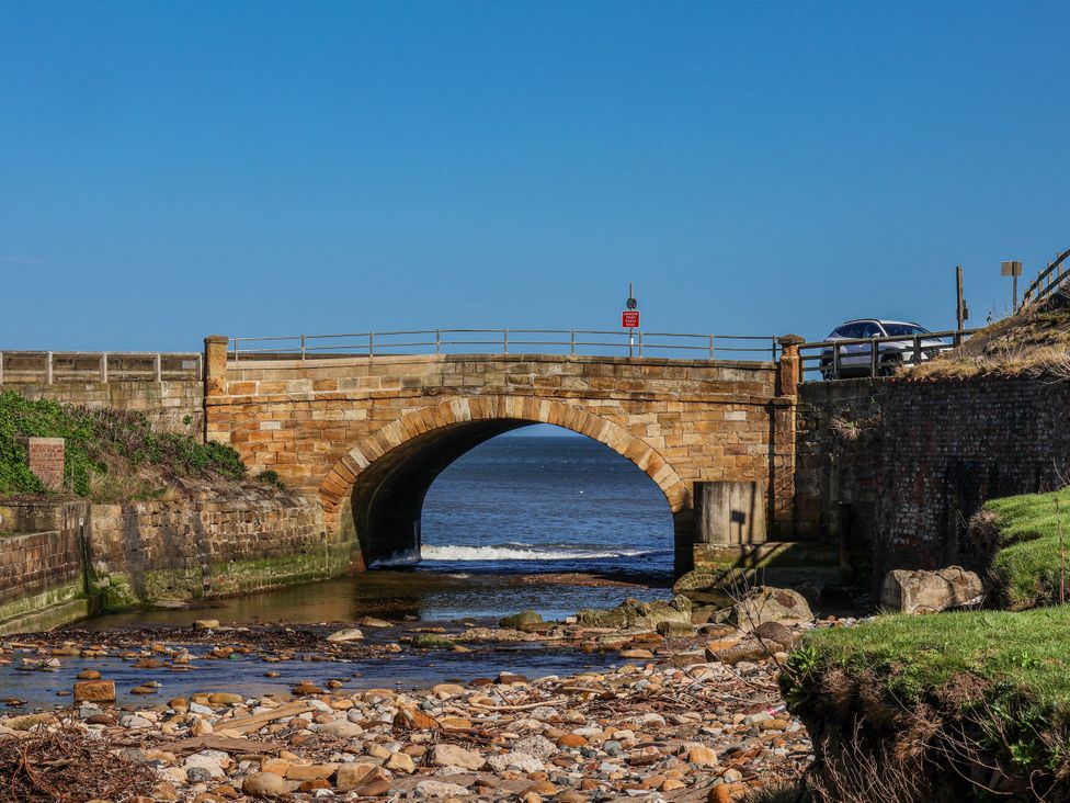 A bridge over a waterway at Rigg Cottage, Mount Pleasant in Sandsend