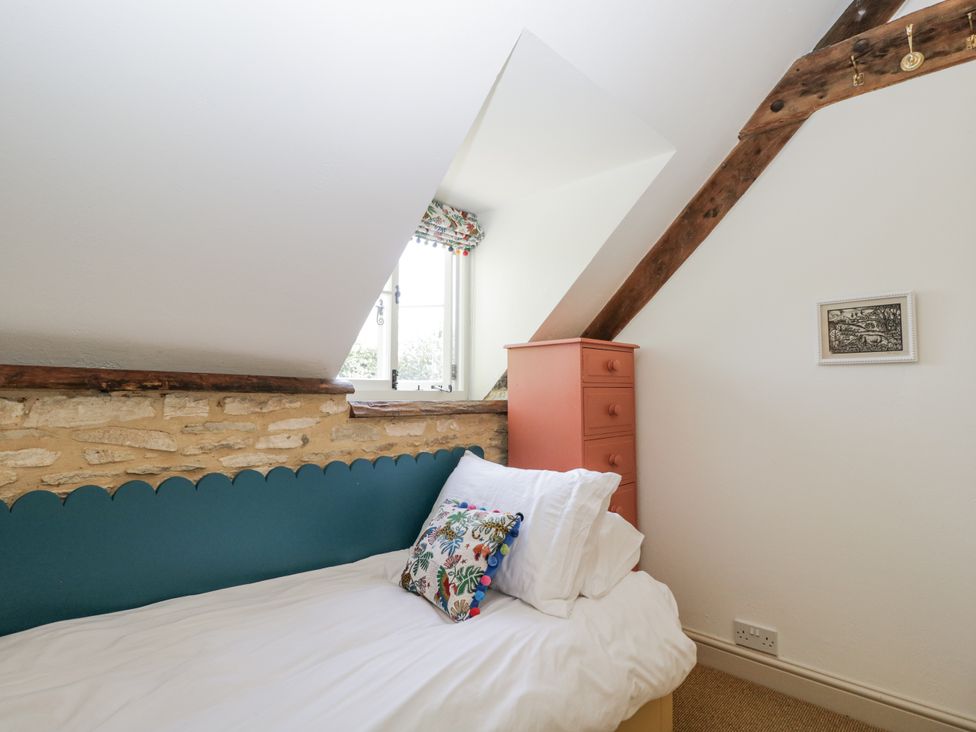 A bedroom with a bed and a window at Stable cottage Sopworth near Sherston