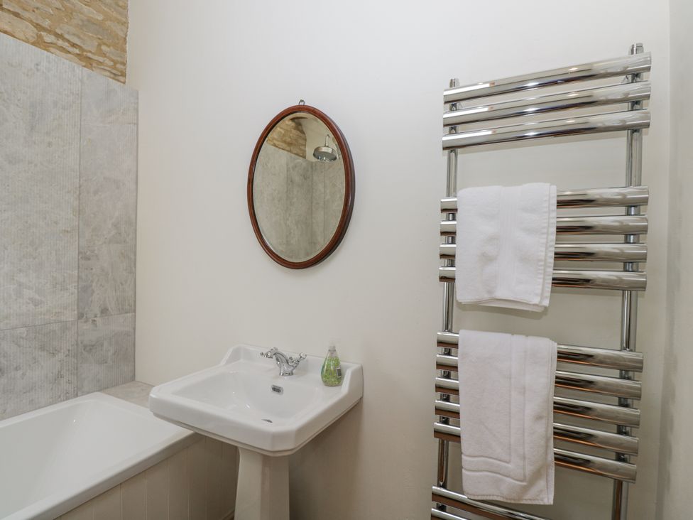 A bathroom with a sink and a bathtub at Stable cottage Sopworth near Sherston
