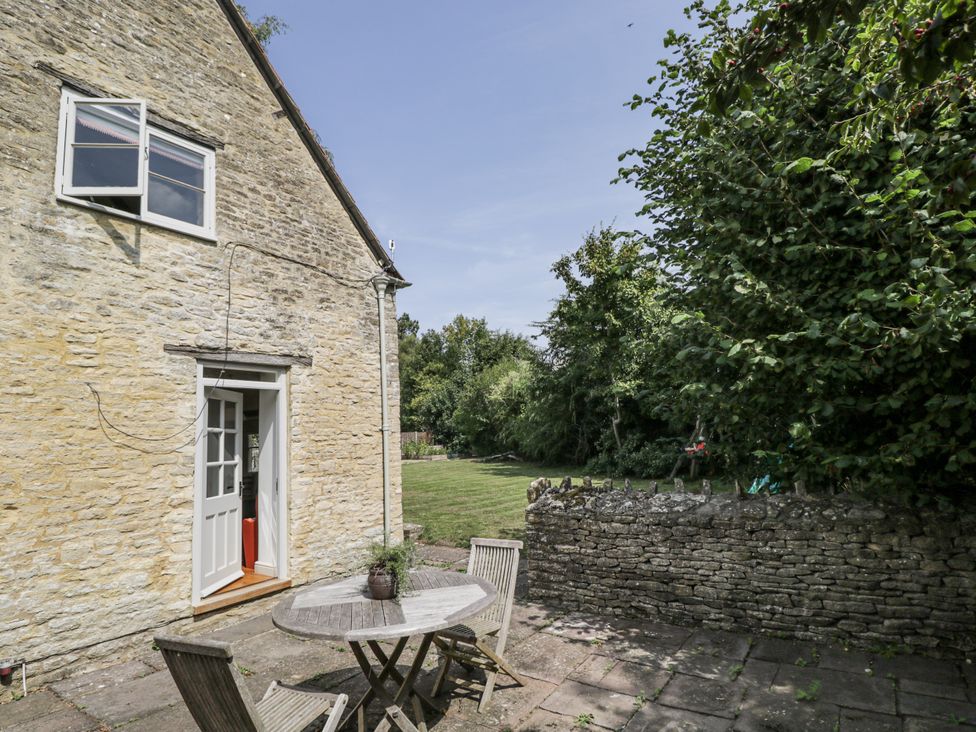 An outdoor area with a table and chairs at Stable cottage in Sopworth near Sherston