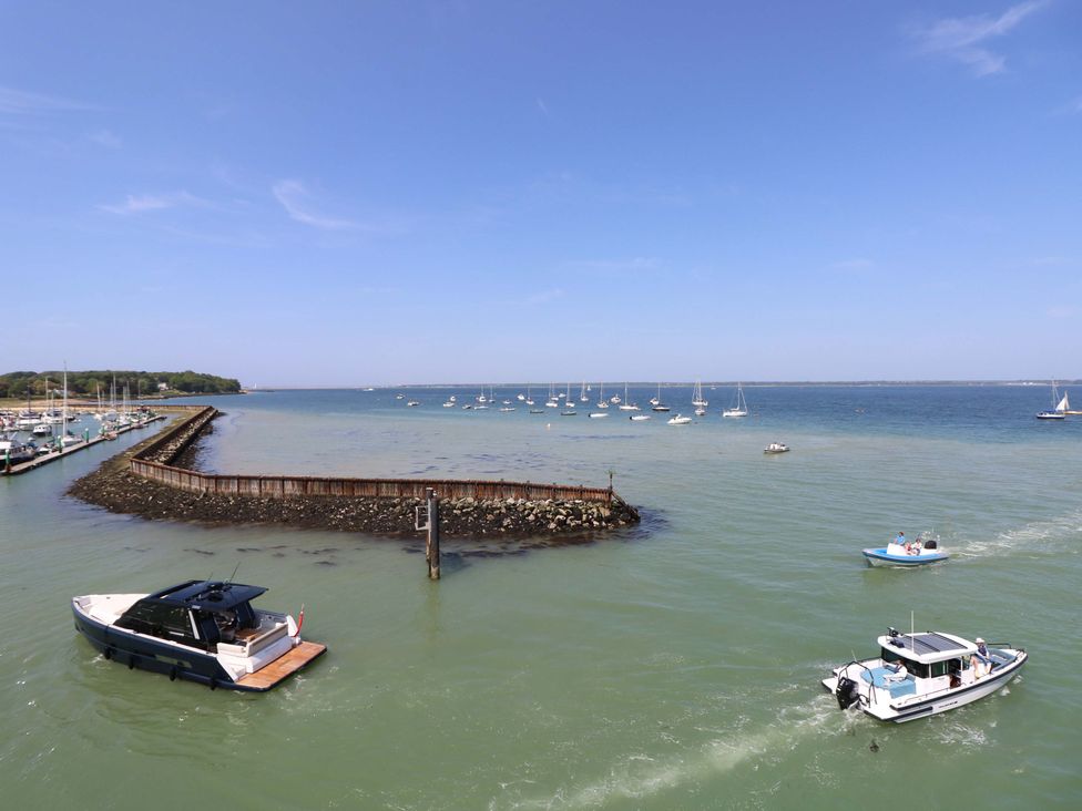 A harbor with boats on the water near a stone and wood breakwater at Whitfield P1 in Yarmouth