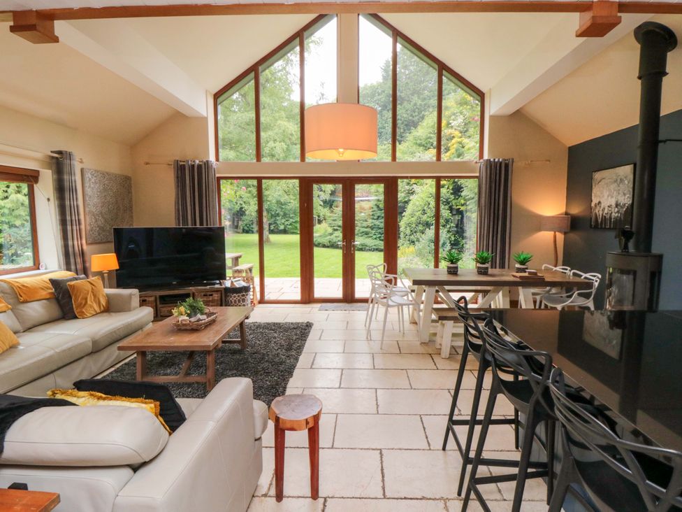 A living room with a sofa and television at Lawnswood