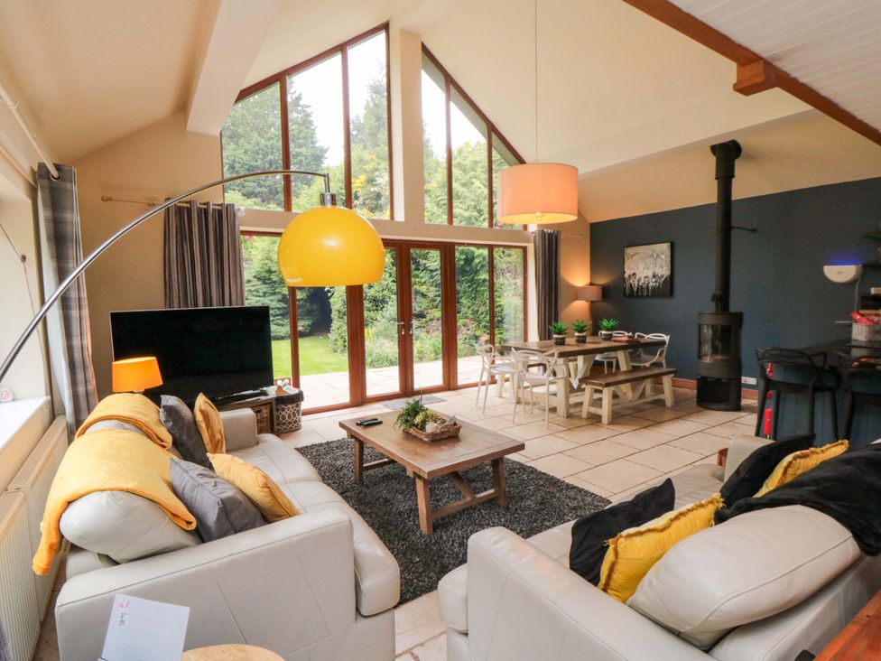 A living room with a television and dining table at Lawnswood