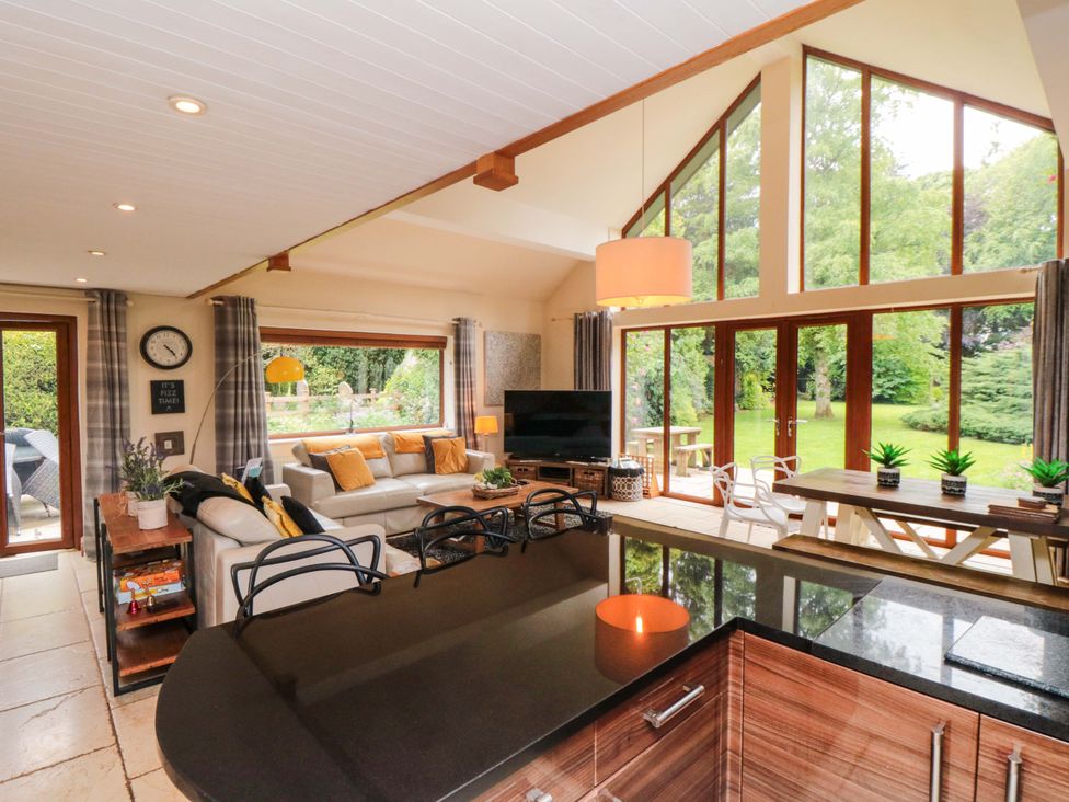A living room with a sofa and dining area at Lawnswood