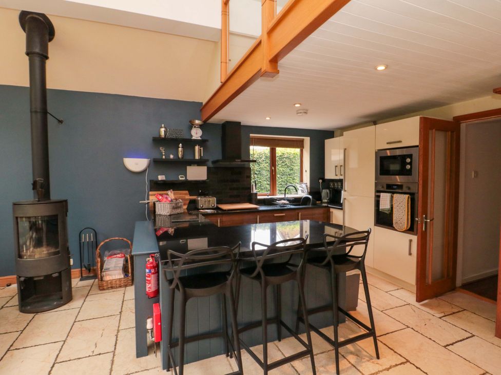A kitchen with a central island and multiple appliances at Lawnswood