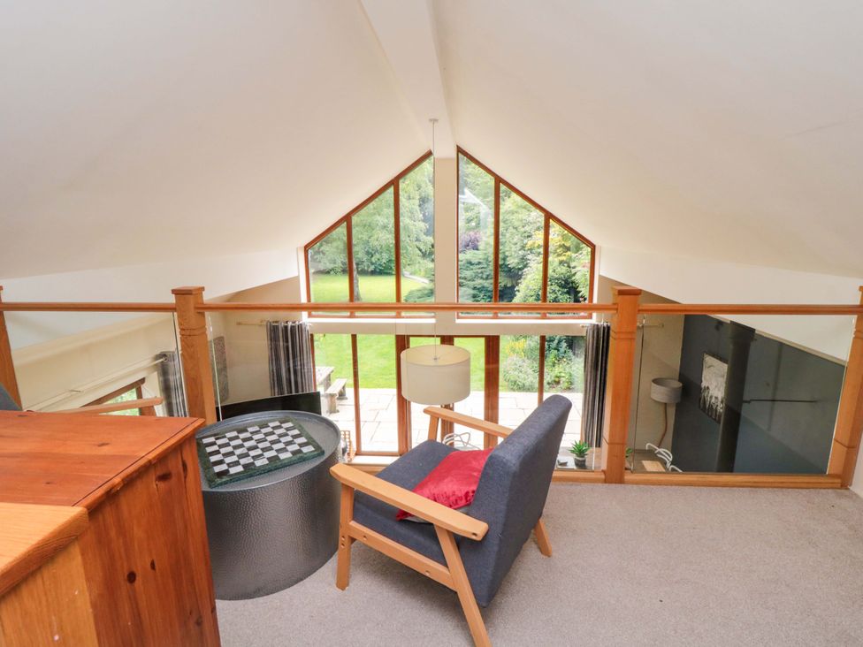 A snug with a chair and table overlooking a garden at Lawnswood