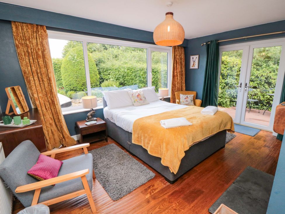 A bedroom with a bed and a chair at Lawnswood