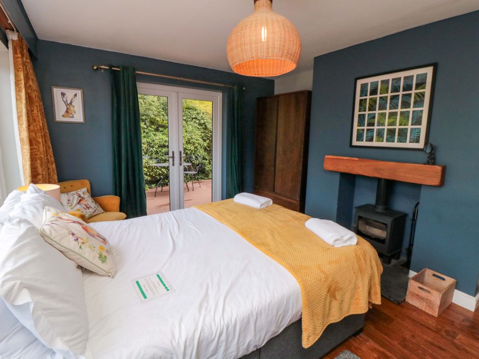 A bedroom with a bed and a door leading to a patio at Lawnswood