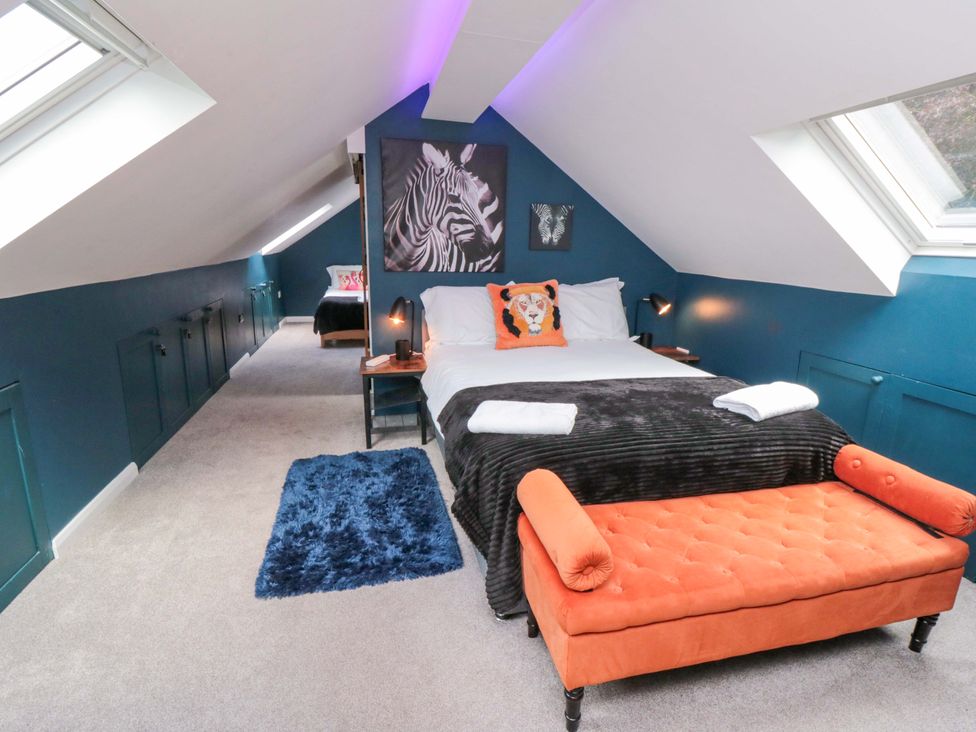 A bedroom with a bed and artwork at Lawnswood