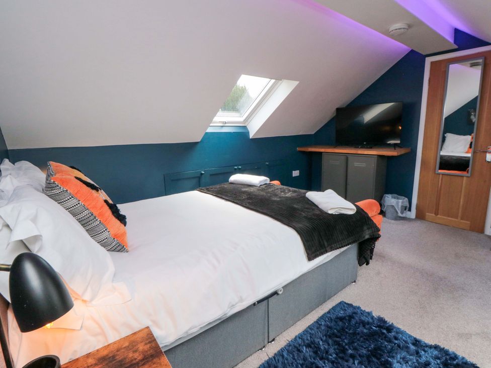 A bedroom with a bed and television at Lawnswood