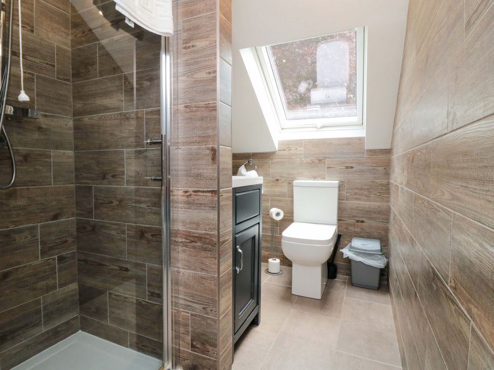 A bathroom with shower, toilet, and sink at Lawnswood
