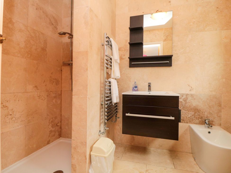 A bathroom with a shower and sink at Lawnswood