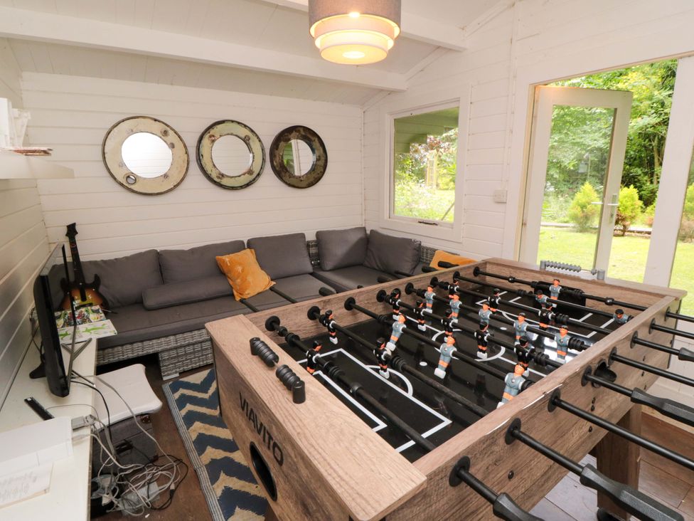 A snug with a foosball table and a sofa at Lawnswood