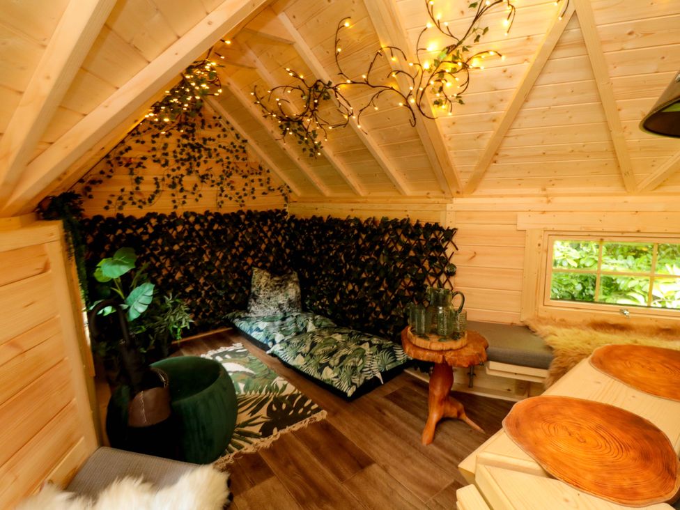 A small indoor space with wooden beams and plants at Lawnswood