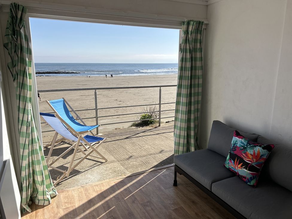 A living room with a view of the beach and ocean at Lawnswood in Brompton-by-Sawdon near Sherburn