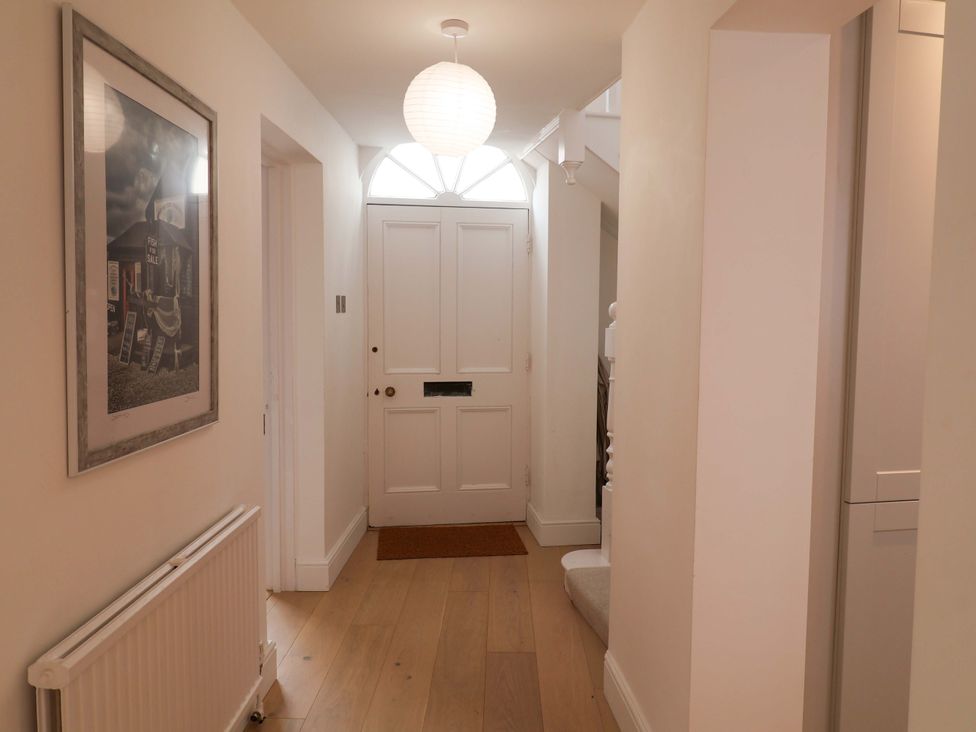 A hallway with a door and a radiator at 11 Ballygate in Babbacombe