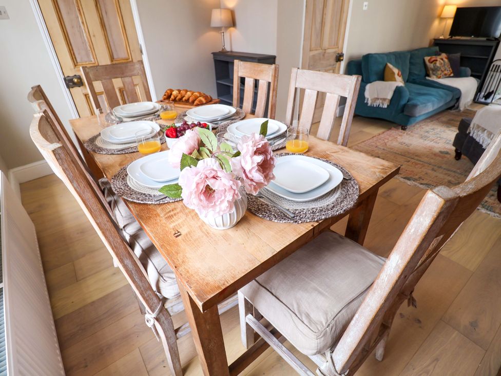 A dining room with a table set for breakfast at 11 Ballygate in Babbacombe