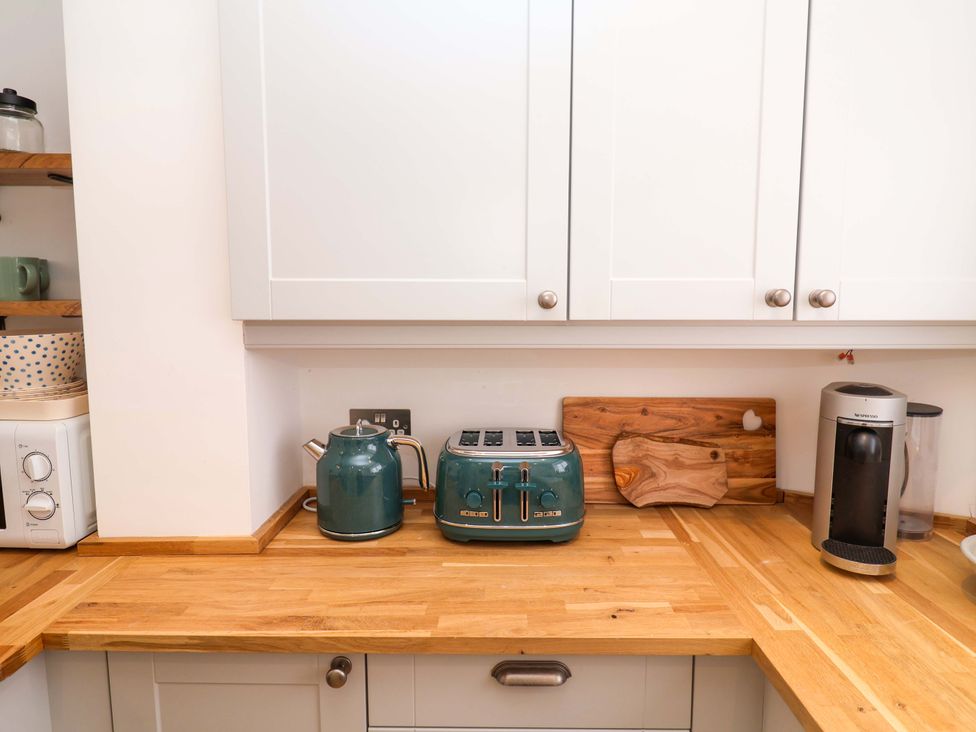 A kitchen with a kettle and toaster on the counter at 11 Ballygate in Babbacombe