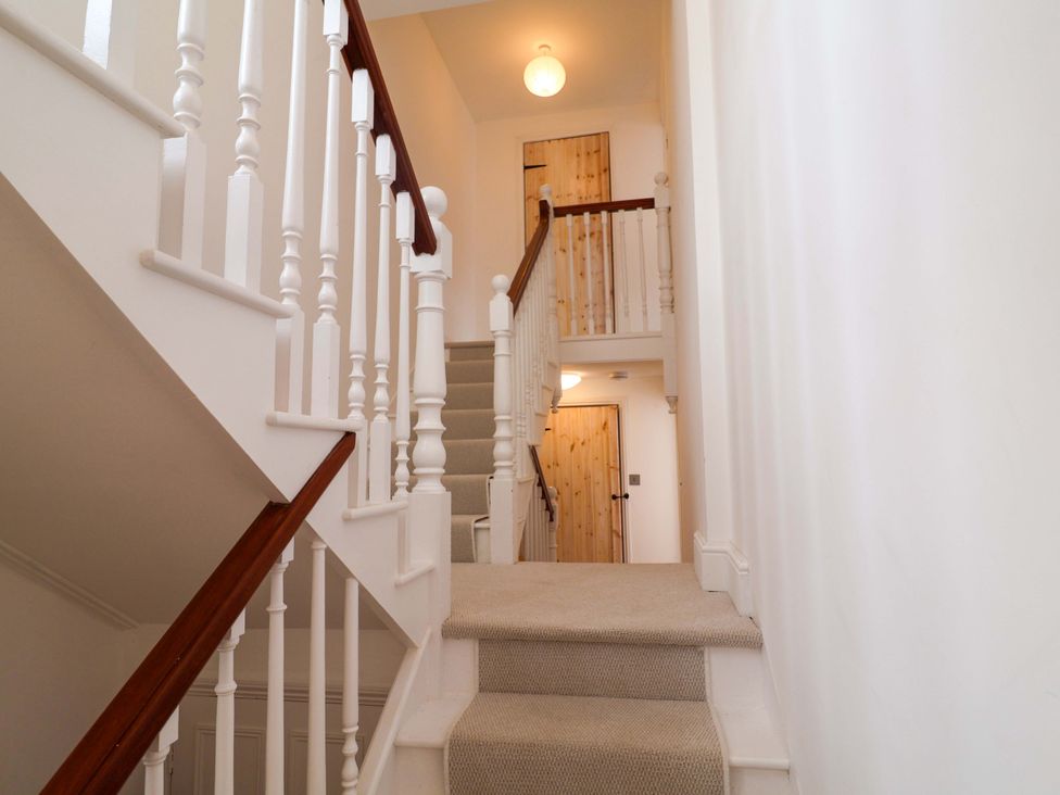 A staircase leading to a landing at 11 Ballygate in Babbacombe