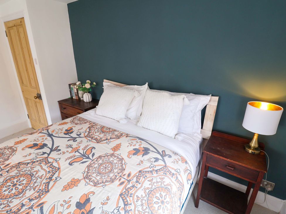 A bedroom with a bed and bedside table at 11 Ballygate in Babbacombe