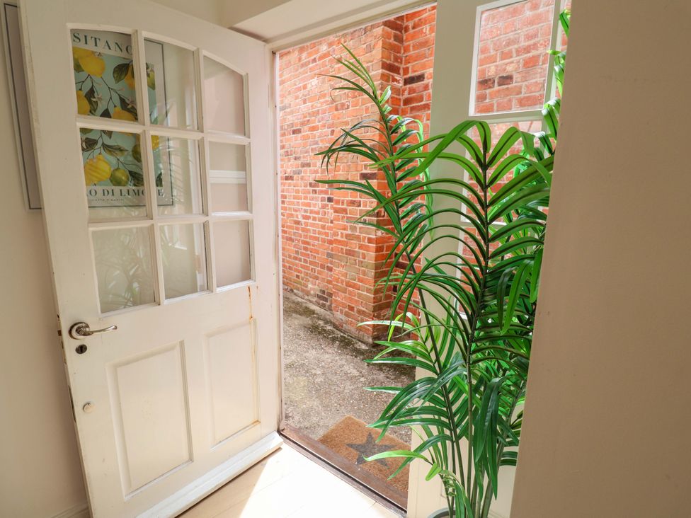 An entrance with a door open to a pathway at 11 Ballygate in Babbacombe