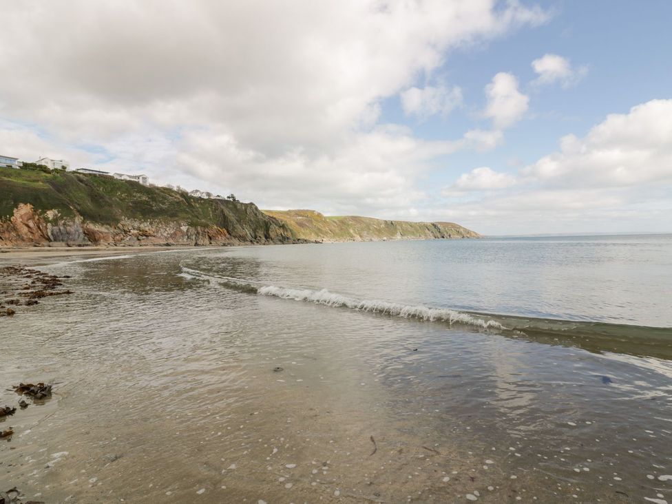 A beach view with water and cliffs at Sunset Cottage in Gorran Churchtown