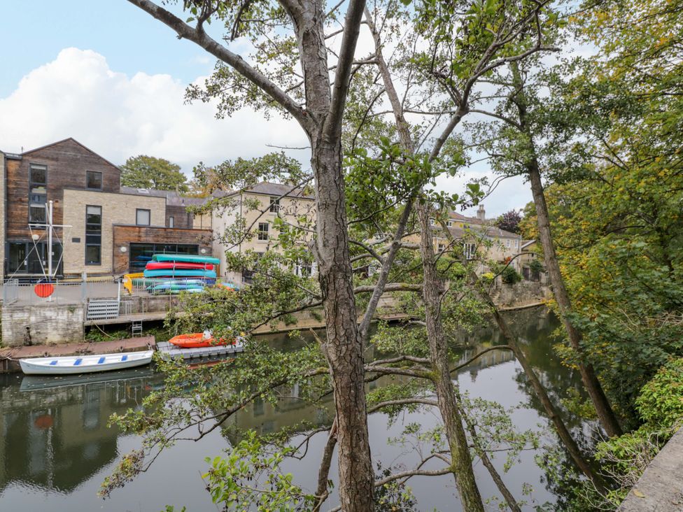 View of river with boats and houses along the bank at 3 The Stoneyard Bath