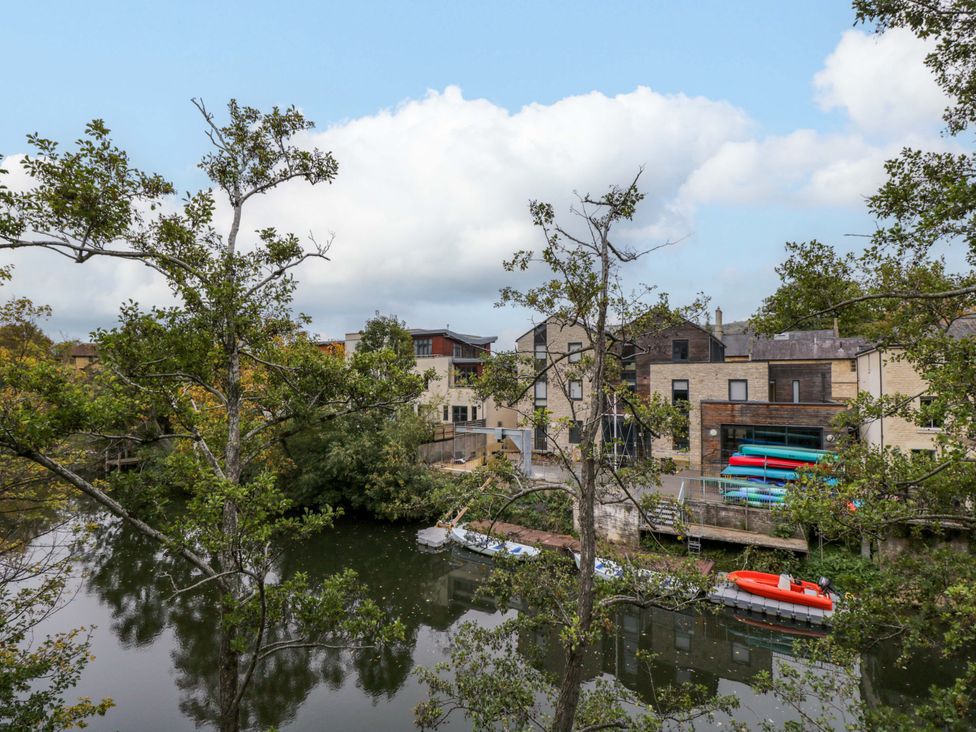 A view of buildings and trees by the river at 3 The Stoneyard in Bath