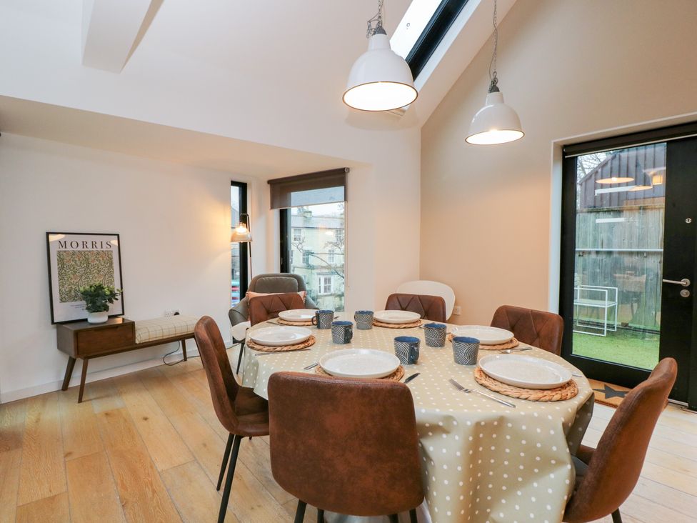 A dining room with a table set for dinner at 3 The Stoneyard in Bath