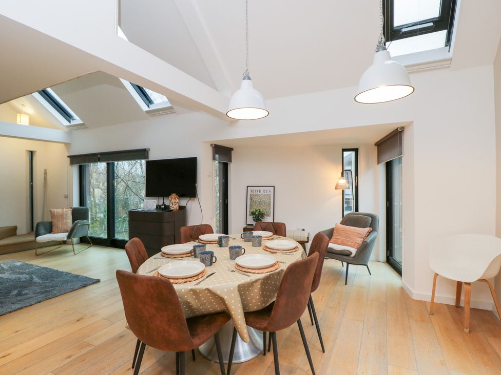 A dining room with a table and chairs at 3 The Stoneyard in Bath