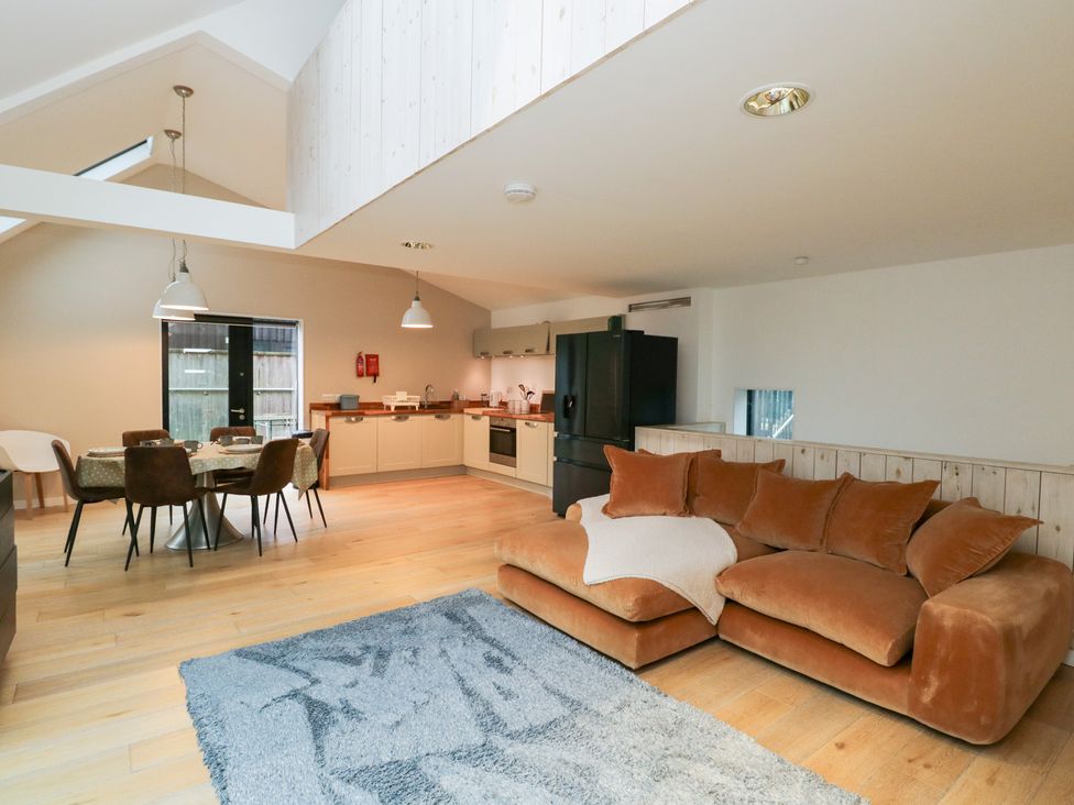 A living room with a sofa and dining area at 3 The Stoneyard, Bath